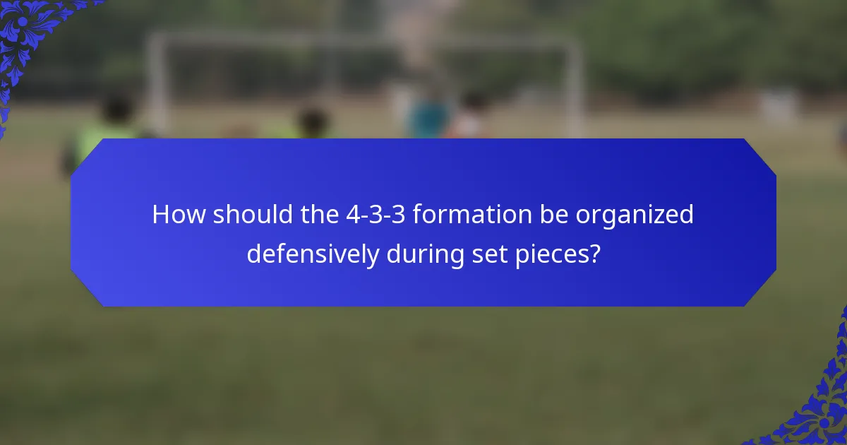 How should the 4-3-3 formation be organized defensively during set pieces?